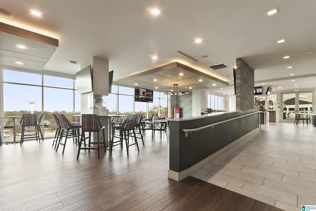 1150 8th St Unit 503, Tuscaloosa, AL 35401 - interior space featuring floor to ceiling windows, a notable chandelier, and light hardwood / wood-style floors