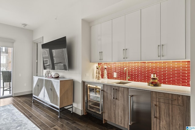 1150 8th St Unit 503, Tuscaloosa, AL 35401 - bar with wine cooler, stainless steel built in refrigerator, sink, dark hardwood / wood-style floors, and backsplash