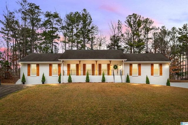 view of front of property featuring a yard and covered porch