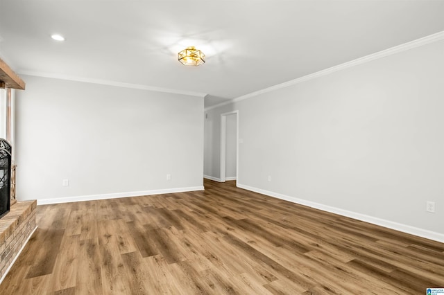 unfurnished living room with ornamental molding, a fireplace, and wood-type flooring