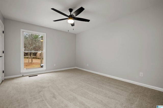 carpeted spare room with ceiling fan