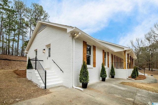 view of side of home featuring a porch