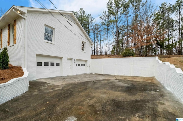 view of side of home featuring a garage