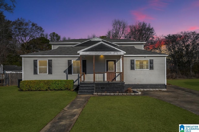 bungalow-style home with a porch and a yard