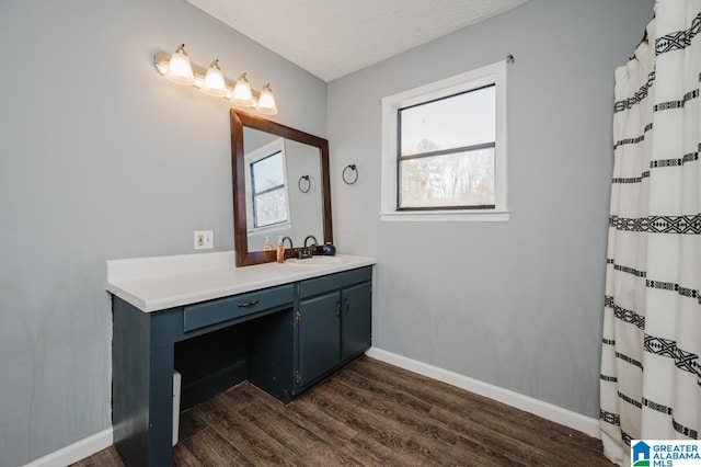 bathroom with hardwood / wood-style flooring, vanity, curtained shower, and a textured ceiling