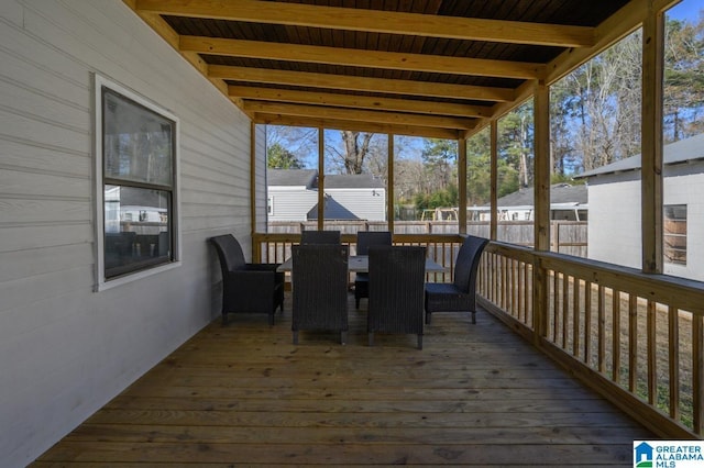 unfurnished sunroom with beam ceiling