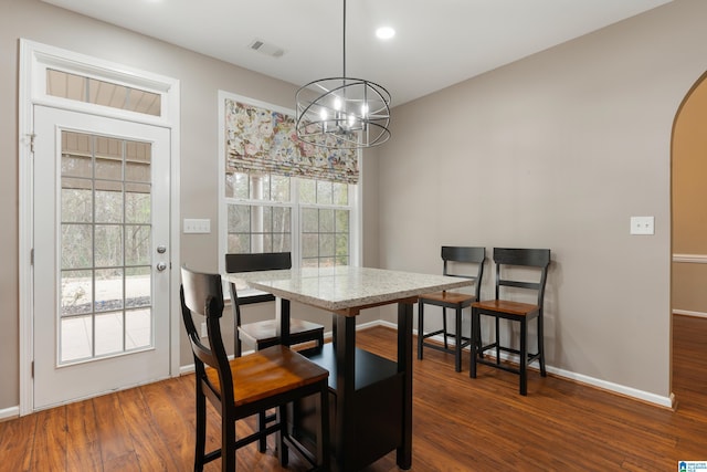 dining area featuring an inviting chandelier and dark hardwood / wood-style flooring