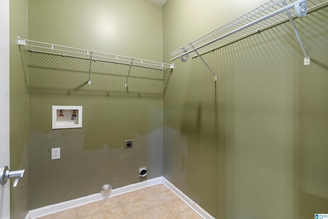 clothes washing area with hookup for a washing machine, gas dryer hookup, and hookup for an electric dryer