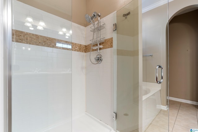 bathroom with independent shower and bath, ornamental molding, and tile patterned floors