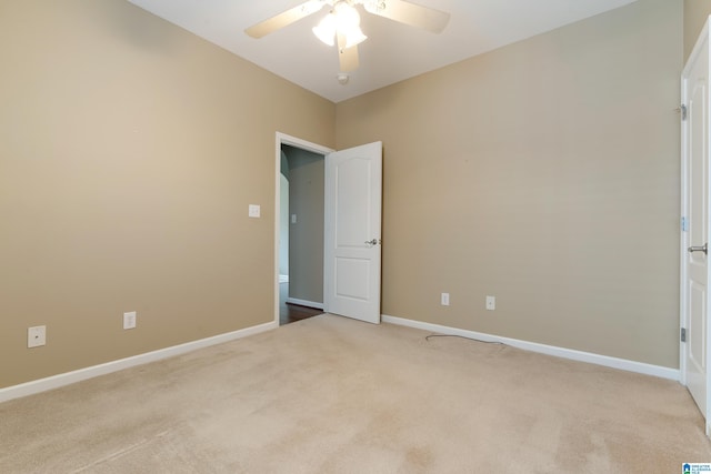 empty room with light carpet and ceiling fan