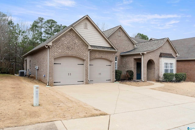 view of front of house featuring a garage and central AC unit