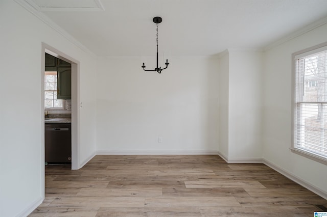 unfurnished dining area featuring ornamental molding and light wood-type flooring