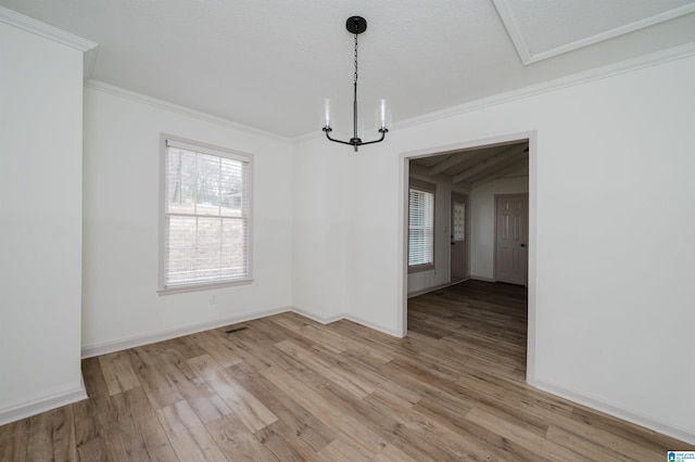 unfurnished dining area featuring crown molding, a notable chandelier, and light hardwood / wood-style flooring