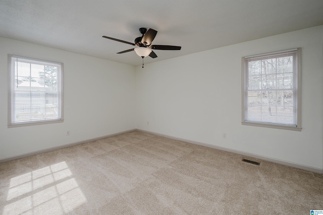 unfurnished room featuring ceiling fan and light carpet