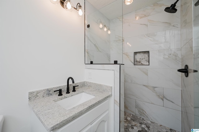 bathroom featuring vanity and a tile shower