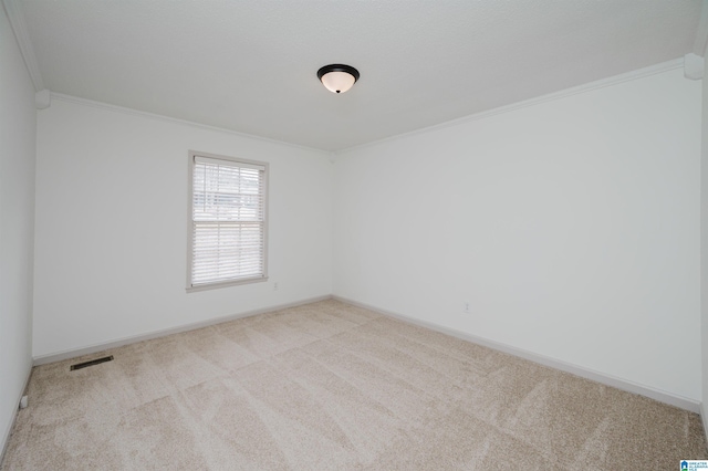 empty room with light carpet and crown molding