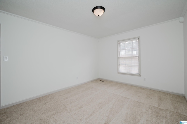 carpeted empty room featuring ornamental molding