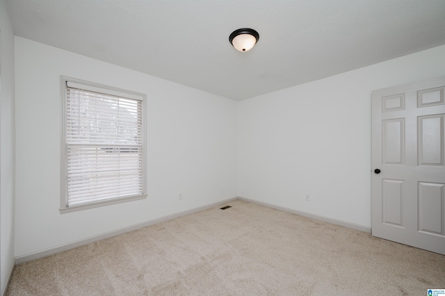 spare room with light colored carpet