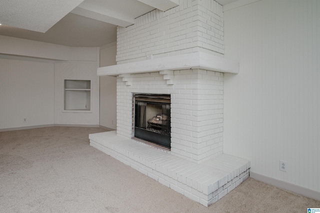 interior details with built in features, a fireplace, and carpet