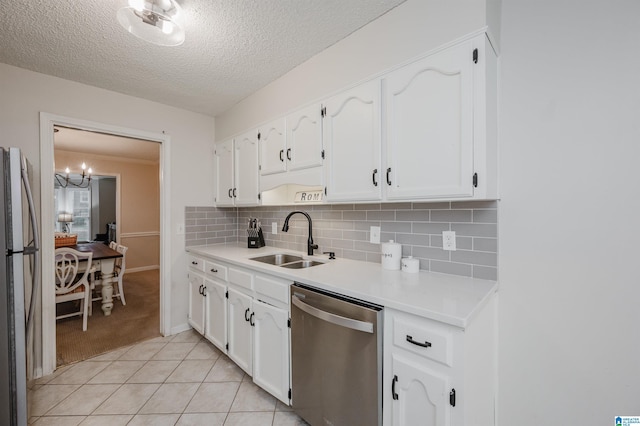 kitchen with sink, white cabinets, decorative backsplash, light tile patterned floors, and stainless steel appliances