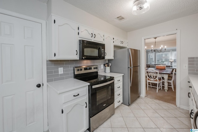 kitchen featuring light tile patterned flooring, tasteful backsplash, a chandelier, stainless steel appliances, and white cabinets