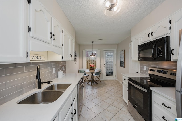 kitchen with sink, white cabinetry, hanging light fixtures, light tile patterned floors, and stainless steel appliances