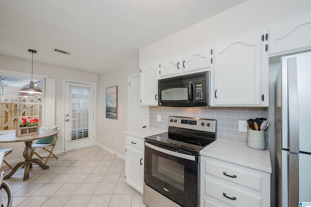 kitchen with pendant lighting, white cabinets, decorative backsplash, light tile patterned floors, and stainless steel appliances