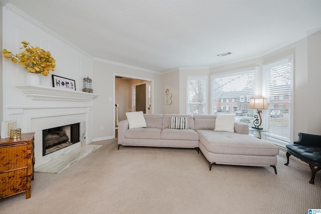 carpeted living room with ornamental molding, a premium fireplace, and a textured ceiling