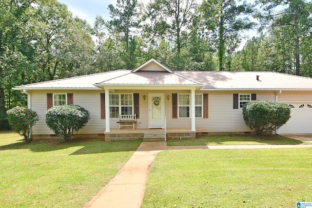 ranch-style home with a garage, covered porch, and a front yard