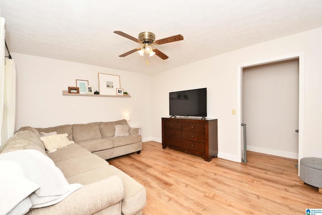 living room with ceiling fan and light hardwood / wood-style flooring