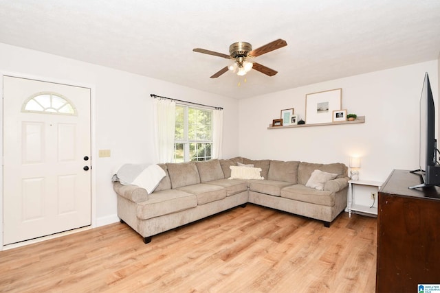 living room featuring light hardwood / wood-style flooring and ceiling fan