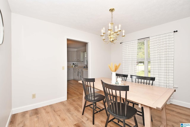 dining room featuring an inviting chandelier and light hardwood / wood-style floors