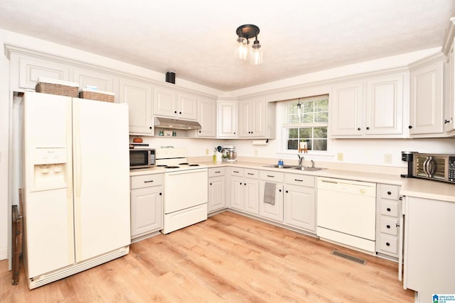 kitchen featuring white cabinetry, sink, white appliances, and light hardwood / wood-style flooring