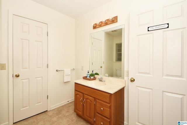 bathroom with vanity and toilet