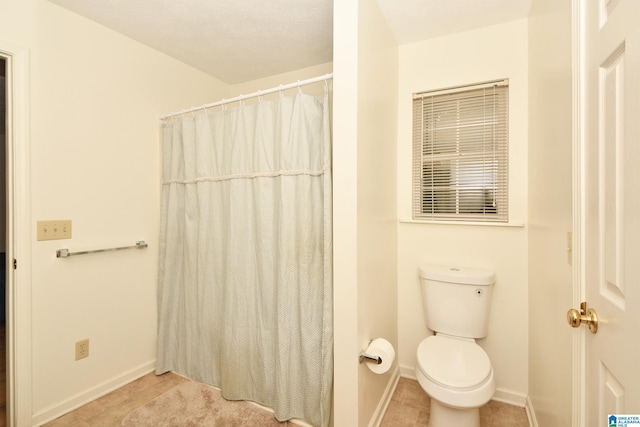 bathroom featuring a shower with curtain, tile patterned floors, and toilet