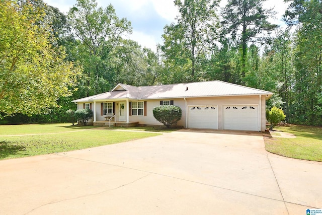 view of front of property with a garage and a front lawn