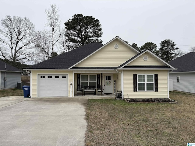 view of front of property with a porch, a garage, and a front lawn