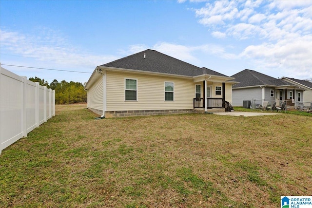 back of house featuring a patio area and a lawn