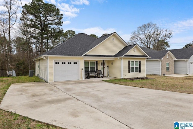 view of front of property featuring a garage, central AC, and a front lawn