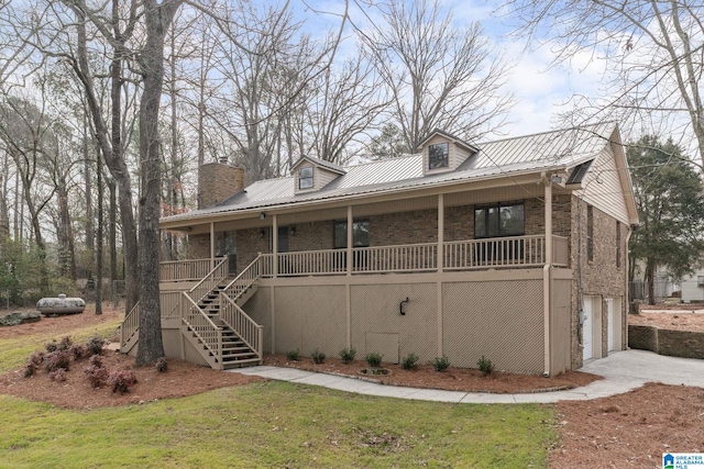 view of front of house featuring a garage, a front yard, and a porch