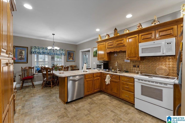 kitchen with decorative light fixtures, brown cabinetry, a sink, white appliances, and a peninsula