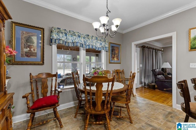 dining area with a notable chandelier, baseboards, and crown molding