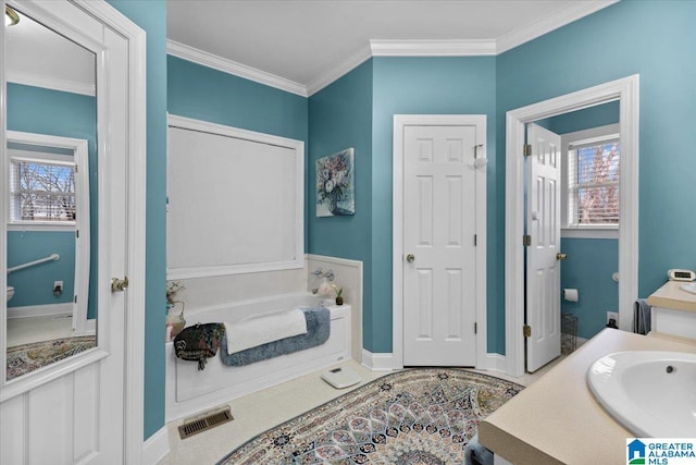 full bath featuring a tub to relax in, visible vents, toilet, crown molding, and vanity