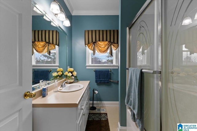 full bath featuring a wealth of natural light, ornamental molding, vanity, and visible vents