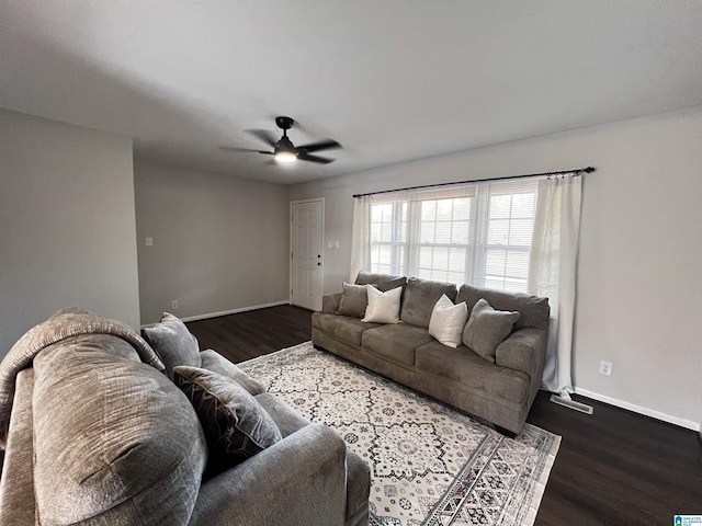 living room featuring dark hardwood / wood-style floors and ceiling fan