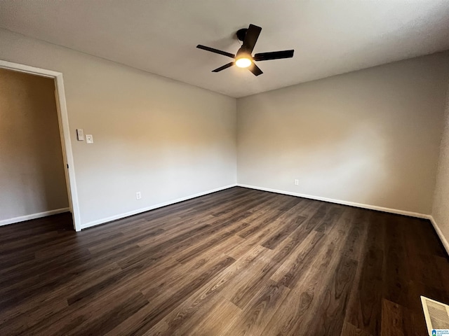 spare room featuring dark hardwood / wood-style floors and ceiling fan