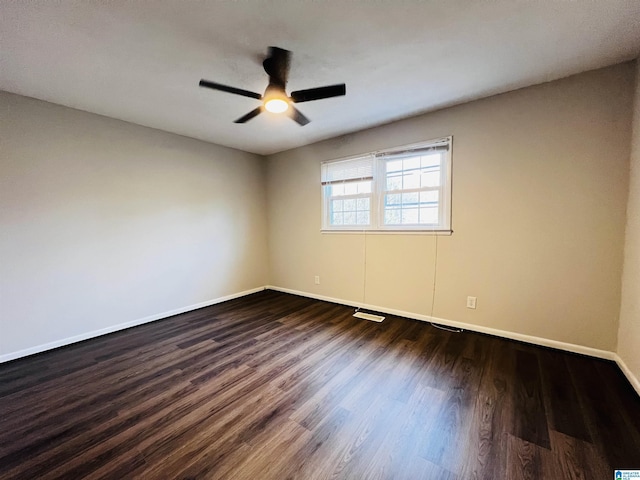 unfurnished room with dark wood-type flooring and ceiling fan