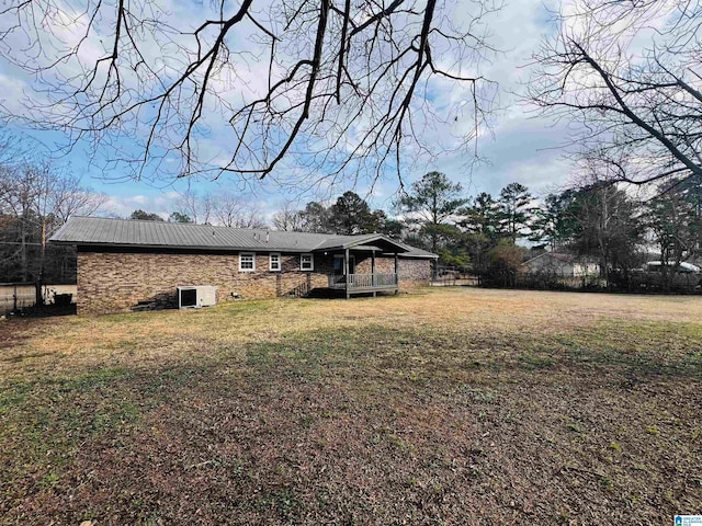 back of house with a lawn