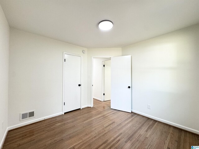 empty room with hardwood / wood-style floors