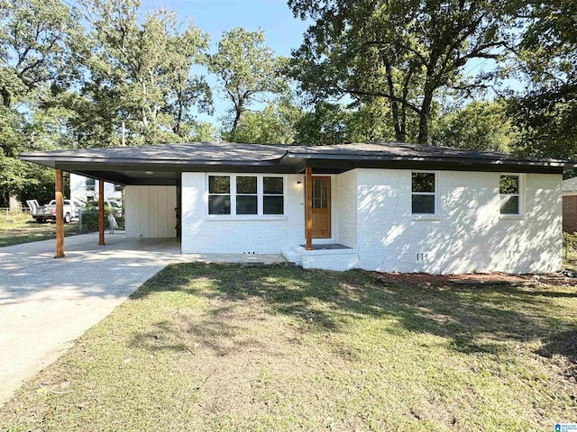 ranch-style home featuring a front yard and a carport